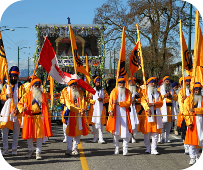 Sikh procession with flags during parade.